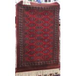 Bokhara rug with typical geometric medallion decoration upon a red ground, 185 x 130 cm