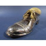 A silver pin cushion in the form of a laced shoe with oak sole, Birmingham 1910, S Blanckensee & Son
