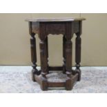 A good quality Old English style oak occasional table of hexagonal form raised on six fluted