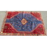 Unique Persian Quashqui Nomad full pile rug, with geometric medallion decoration upon a red and blue