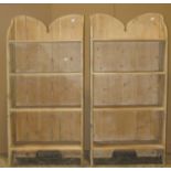 A pair of rustic dwarf stripped pine freestanding open bookcases, with fixed shelves and shaped
