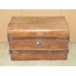 A vintage fibre and wooden lathe bound domed top travelling trunk, together with two further tin