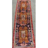 Iranian Baluchi tribal runner with still life and medallion panels upon a navy blue and red