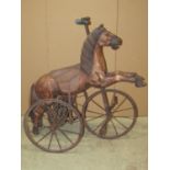 A Victorian style child's horse tricycle velocipede with pivoting front wheel embossed leather