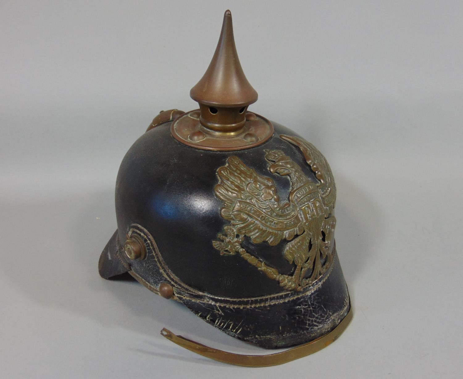 19th century German/Pussian Picklehaube helmet in black leather with a brass spike and applied crest