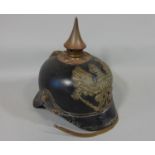 19th century German/Pussian Picklehaube helmet in black leather with a brass spike and applied crest