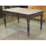 A Victorian scrub top pine kitchen table of rectangular form with moulded outline over an end frieze