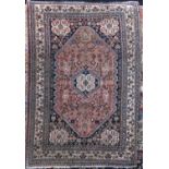 Good quality intricate rug of small proportions with various floral medallions upon a washed red and