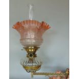 A Victorian oil lamp brass wall bracket, the bracket in the gothic style, the cut glass font with