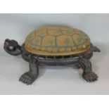 An unusual Victorian footstool in the form of a tortoise, with carved timber body, the shell in hand