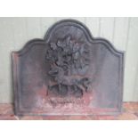 A heavy cast iron fire back of rectangular and shaped arched form with raised relief horse and