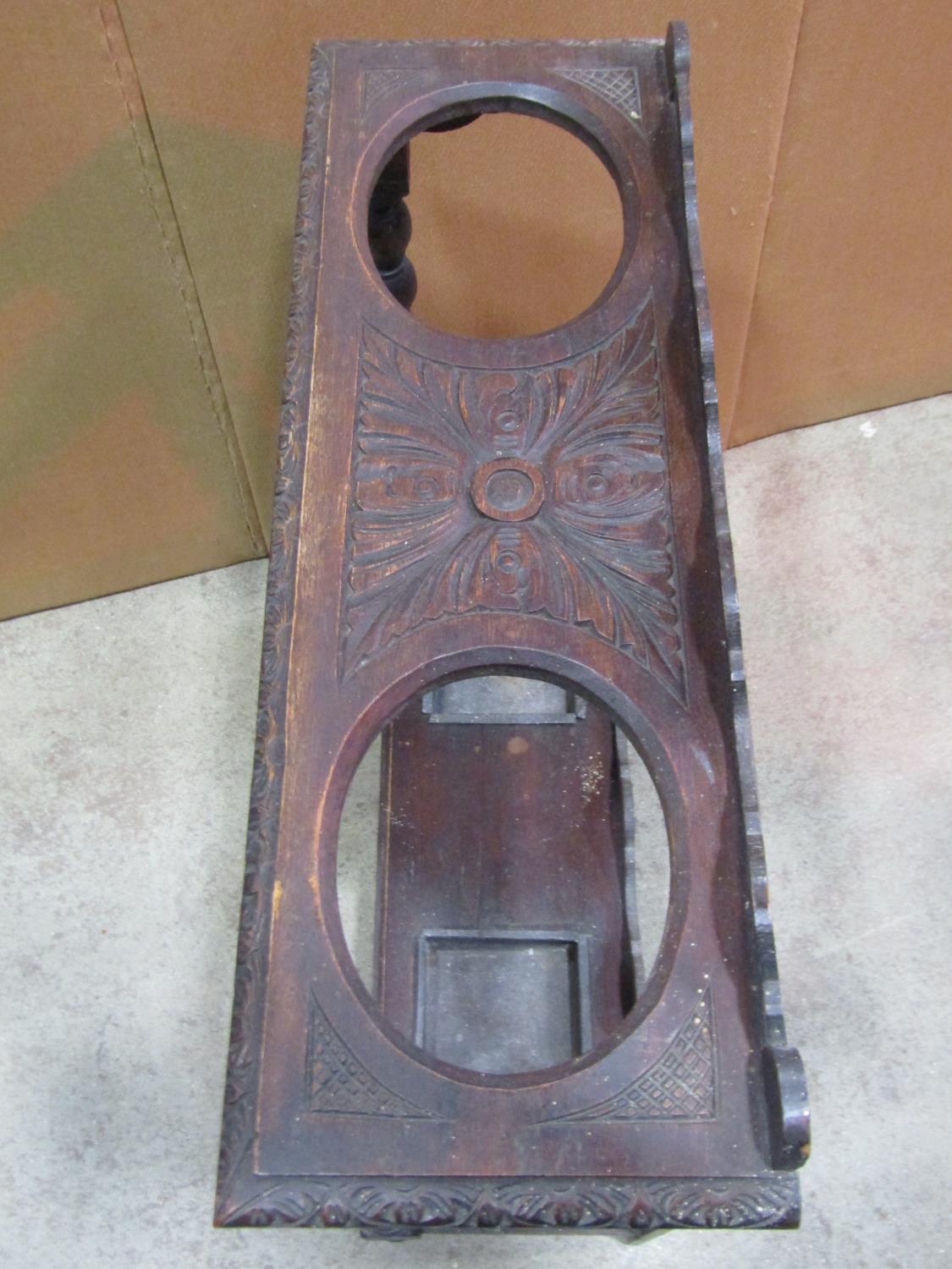 A Victorian Gothic carved oak umbrella/stick stand, with two oval cut out divisions and turned - Image 3 of 3