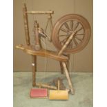A traditional spinning wheel in beech with turned spindles, stamped underneath G W Cummeber, Watleys