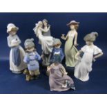A Lladro Daisa figure group of a bride and groom together with six Nao figures including a girl with
