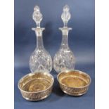 Pair of silver plated wine coasters, embossed with darted bands, 15cm diameter; together with a pair
