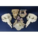 A pair of late 19th century Minton white glazed wall brackets modelled as winged cherubs and with