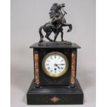 19th century black slate architectural mantle clock, mounted by a cast metal Marley horse, the