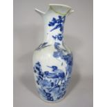 A 19th century oriental vase with blue painted decoration of various birds including peacock, stork,