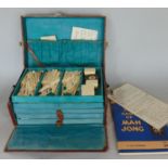 A small leather case containing a Mahjong set with instructions