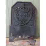 An antique cast iron fireback with canted corners, raised relief armorial shield with crown, dated