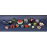 A collection of 17 floral glass paperweights and dumps