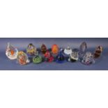 A collection of 13 glass dump paperweights to include a Mdina example