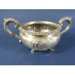Irish silver sugar basin, of circular form, with embossed floral detail, two loop handles and
