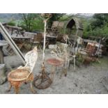A large quantity of salvaged gardenware including stands, cast iron frame, folding chair, further
