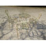 A five piece decorative iron terrace set, the circular table, 60 cm diameter with glass top,