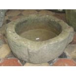 An ancient stone mortar, circular with shaped outline, 45 cm diameter