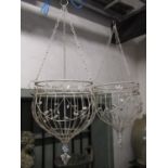 A pair of wirework hanging baskets with simple floral detail, 1 metre in height including chain