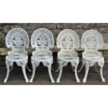 A set of four cast aluminium garden chairs of classic design with acanthus leaf backs, together with