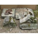 A limestone drain cover of rectangular form, a further limestone domed cap and two further carved