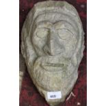 A limestone carving of a rustic male head, with beard, 28cm