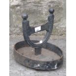 A 19th century iron work foot scraper raised on an oval base