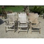 A set of six weathered teakwood folding armchairs with slatted seats and backs