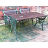 A reclaimed garden table with ironwork frame and teak top together with two matching armchairs (