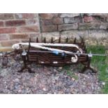 A 19th century steel yard arm, iron work fire basket and dogs and a pair of heavy Victorian iron