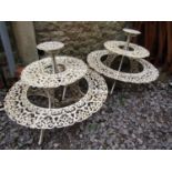 A pair of decorative cast iron three tier circular and graduated plant stand, 1 metre diameter