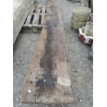 A large architectural beam in teak, one side with arched outline, 3.45m in length x 10 cm deep x 43
