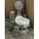 A turned ball finial on stand, four small limestone stands, bird bath of octagonal form, etc (8
