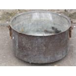 A beaten copper cauldron with iron work loop handle, 50 cm diameter