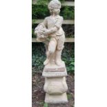Reclaimed figure of a boy holding fruit standing upon a plinth 120 cm approx