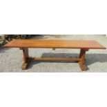 A traditional oak refectory table, the heavy plank top with cleated ends raised on a stretcher