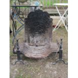 An early cast iron fireback 68 cm x 43 cm, together with fire basket and iron
