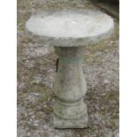 A turned baluster shaped column and a circular top, to display a garden pot or ornament, 48cm high