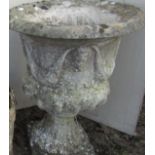 A campana shaped urn with mask and swag detail on square cut base