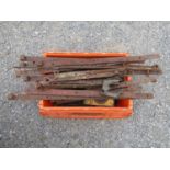 A quantity of salvaged ironware including early agricultural gate hinges, cow bell, drain covers,