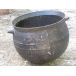 A large 19th century cast iron cauldron with two lug handles, 60 cm diameter approximately