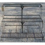 An iron three tier stepped plant stand, 97 cm wide x 75 cm in height x 60 cm maximum depth